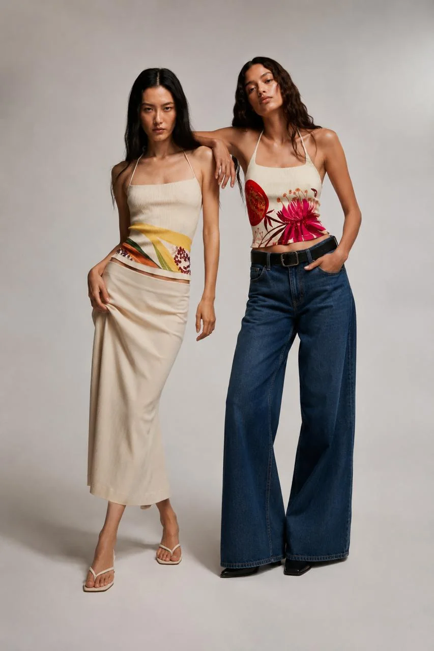 Bloom Tops cover — the Malibu bloom halter worn with wide-leg denim beside the Zesty halter with a cream maxi skirt.