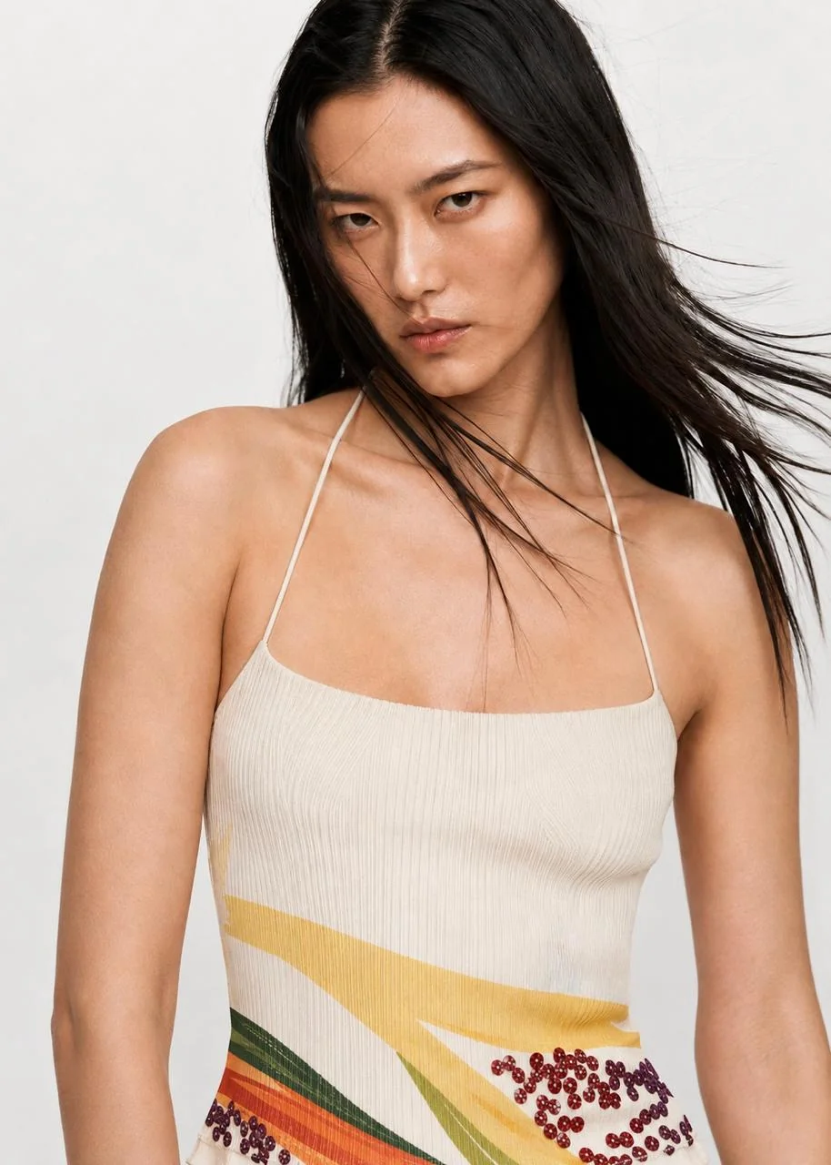 Close-up of the Zesty top — layered citrus and melon print across the hem.