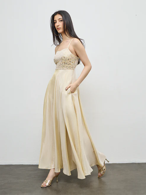 Festive Occasionwear cover — the finished beige zari-tissue gown, three-quarter view.